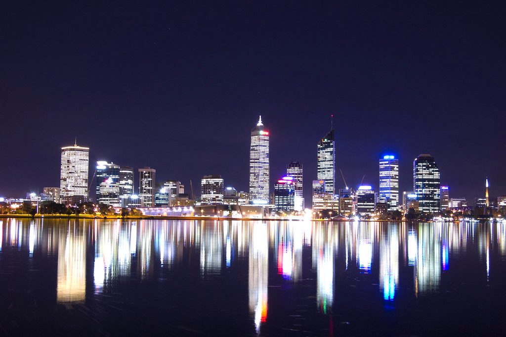 Perth city skyline reflected across the Swan River at dusk